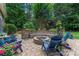 Cozy fire pit area surrounded by lush greenery and comfortable seating, perfect for outdoor gatherings at 2541 Penngate Dr, Sherrills Ford, NC 28673