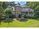 Beautiful home featuring a stone turret, manicured landscaping, and a charming covered porch at 2541 Penngate Dr, Sherrills Ford, NC 28673