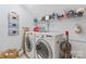Well-equipped laundry room with modern washer and dryer, shelving, and storage options at 2541 Penngate Dr, Sherrills Ford, NC 28673