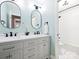 Bathroom with double vanity, two oval mirrors, and a shower-tub combo at 314 Southern Cross Ln, Matthews, NC 28105