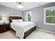 Bedroom with neutral walls, plush carpet, and a large window providing natural light at 314 Southern Cross Ln, Matthews, NC 28105