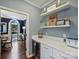 Elegant butler's pantry with wine fridge, marble counters, and ample storage for entertaining needs at 314 Southern Cross Ln, Matthews, NC 28105
