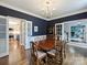 Inviting dining room with hardwood floors, classic furniture, and seamless flow to kitchen at 314 Southern Cross Ln, Matthews, NC 28105