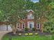 Charming two-story brick home with a well-manicured front yard and inviting curb appeal at 314 Southern Cross Ln, Matthews, NC 28105