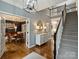 Elegant foyer with hardwood floors, staircase, and a view of the dining and living areas at 314 Southern Cross Ln, Matthews, NC 28105