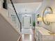 Bright foyer with hardwood floors, staircase, and a view of the front door and garden at 314 Southern Cross Ln, Matthews, NC 28105