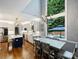 Bright, modern kitchen with stainless steel appliances, a large island, and a view of the pool at 314 Southern Cross Ln, Matthews, NC 28105