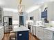 Well-lit kitchen boasts stainless appliances, white cabinets, marble countertops, and a central island at 314 Southern Cross Ln, Matthews, NC 28105