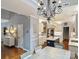Open-concept kitchen featuring white cabinets, stainless appliances, and a central island for ample counter space at 314 Southern Cross Ln, Matthews, NC 28105