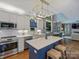 Open kitchen featuring a large island, stainless appliances, and a seamless view into the dining area at 314 Southern Cross Ln, Matthews, NC 28105