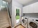 Convenient laundry room with modern washer and dryer, storage cabinets, and access to the backyard at 314 Southern Cross Ln, Matthews, NC 28105