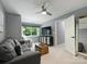 Cozy living room with a ceiling fan and door to an adjoining room at 314 Southern Cross Ln, Matthews, NC 28105