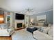 Cozy living room with a fireplace, ceiling fan, and comfortable seating, perfect for relaxing at 314 Southern Cross Ln, Matthews, NC 28105