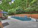 Backyard with in-ground pool, patio, mature trees, privacy fence, and basketball hoop, for entertaining and play at 314 Southern Cross Ln, Matthews, NC 28105