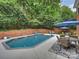 Backyard with an in-ground pool, patio, lounge area, mature trees, privacy fence, and room for entertainment and play at 314 Southern Cross Ln, Matthews, NC 28105