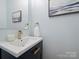 Elegant powder room featuring a sleek vanity, modern faucet, and stylish decor at 314 Southern Cross Ln, Matthews, NC 28105