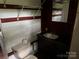 Bathroom featuring a sink, vanity, and wood paneled walls with storage shelves at 326 Havencrest Ct, Gastonia, NC 28052
