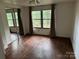 This spacious bedroom features wood flooring, a closet, and a window with natural light and curtains at 326 Havencrest Ct, Gastonia, NC 28052
