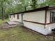 Side exterior view of the manufactured home with wooden deck and siding at 326 Havencrest Ct, Gastonia, NC 28052