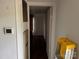 Hallway with thermostat and ladder, featuring tile flooring, leading to a bedroom at 326 Havencrest Ct, Gastonia, NC 28052