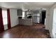 Open-concept kitchen featuring grey cabinets, appliances and hardwood floors at 326 Havencrest Ct, Gastonia, NC 28052