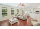 Open-concept living room with hardwood floors, modern sofa, lots of windows, and adjacent dining area at 3326 Park South Station Blvd, Charlotte, NC 28210