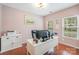 Bright home office with light pink walls, hardwood floors, and a modern white desk at 3326 Park South Station Blvd, Charlotte, NC 28210