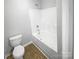 Bathroom featuring a tub and shower combination with a modern white toilet and a sink at 4122 Munson Dr, Charlotte, NC 28215