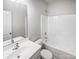 Bright bathroom featuring a tub and shower combination with a modern white vanity and sink at 4122 Munson Dr, Charlotte, NC 28215