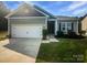 Charming single Gathering home with a two-car garage and a well-maintained lawn at 4122 Munson Dr, Charlotte, NC 28215