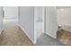 Hallway with access to a bright bathroom, a cozy bedroom, and a welcoming living area at 4122 Munson Dr, Charlotte, NC 28215