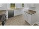 Modern kitchen boasts granite countertops, white cabinets, stainless steel appliances, and vinyl flooring at 4122 Munson Dr, Charlotte, NC 28215