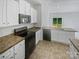 Well-equipped kitchen featuring white cabinets, modern appliances, and granite countertops at 4122 Munson Dr, Charlotte, NC 28215