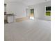 Spacious, naturally lit living room featuring plush carpeting, windows, and sliding glass doors leading to the backyard at 4122 Munson Dr, Charlotte, NC 28215