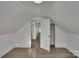 Finished attic space with access door, new flooring, and fresh paint at 4315 Gibbon Rd, Charlotte, NC 28269