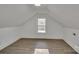 Finished attic space featuring new flooring, fresh paint, and a bright window at 4315 Gibbon Rd, Charlotte, NC 28269