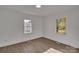 Inviting bedroom with wood-look flooring and plenty of natural light from two windows at 4315 Gibbon Rd, Charlotte, NC 28269