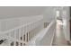 Upstairs hallway showcasing sleek railing design with natural light at 4315 Gibbon Rd, Charlotte, NC 28269