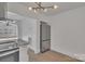 Modern kitchen with stainless steel refrigerator and view into another living space at 4315 Gibbon Rd, Charlotte, NC 28269