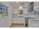 Sun-filled kitchen featuring white cabinets, granite countertops, and stainless steel appliances at 4315 Gibbon Rd, Charlotte, NC 28269