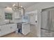 Bright kitchen boasts stainless appliances, granite countertops and modern lighting fixtures at 4315 Gibbon Rd, Charlotte, NC 28269