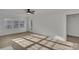 Sunlit living room features hardwood floors and large windows with backyard views at 4315 Gibbon Rd, Charlotte, NC 28269