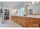 Bathroom with double sinks, wood cabinets, and a closet at 4681 Dove Point Ln, York, SC 29745