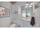 Cozy bathroom with a toilet, vanity, mirror, cabinet, and decorative artwork at 4681 Dove Point Ln, York, SC 29745