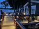 Illuminated deck at twilight with comfortable seating and views of the serene lake at 4681 Dove Point Ln, York, SC 29745