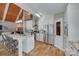 Bright kitchen with granite island, white cabinets, stainless appliances and views to the living room at 4681 Dove Point Ln, York, SC 29745