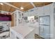 Open kitchenette with white cabinets, an island, a retro-style refrigerator, and an adjacent sitting area at 4681 Dove Point Ln, York, SC 29745