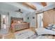 Relaxing bedroom showcases exposed beams, hardwood floors, and a sliding barn door at 4681 Dove Point Ln, York, SC 29745