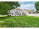 Spacious backyard featuring a well-maintained lawn and the rear exterior of a charming home at 5002 Abode Lily Ln, Charlotte, NC 28227