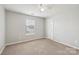 Bright bedroom with carpet, one window, and a ceiling fan at 5002 Abode Lily Ln, Charlotte, NC 28227